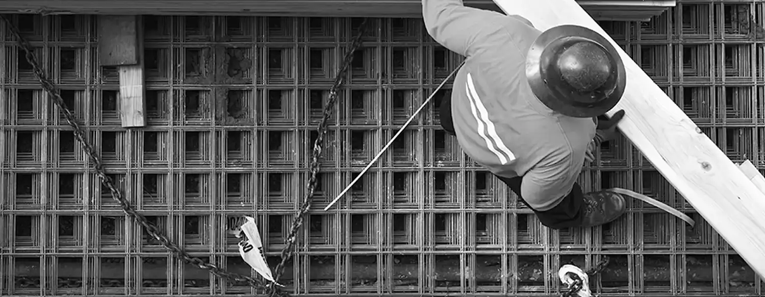 Construction worker walking on rebar