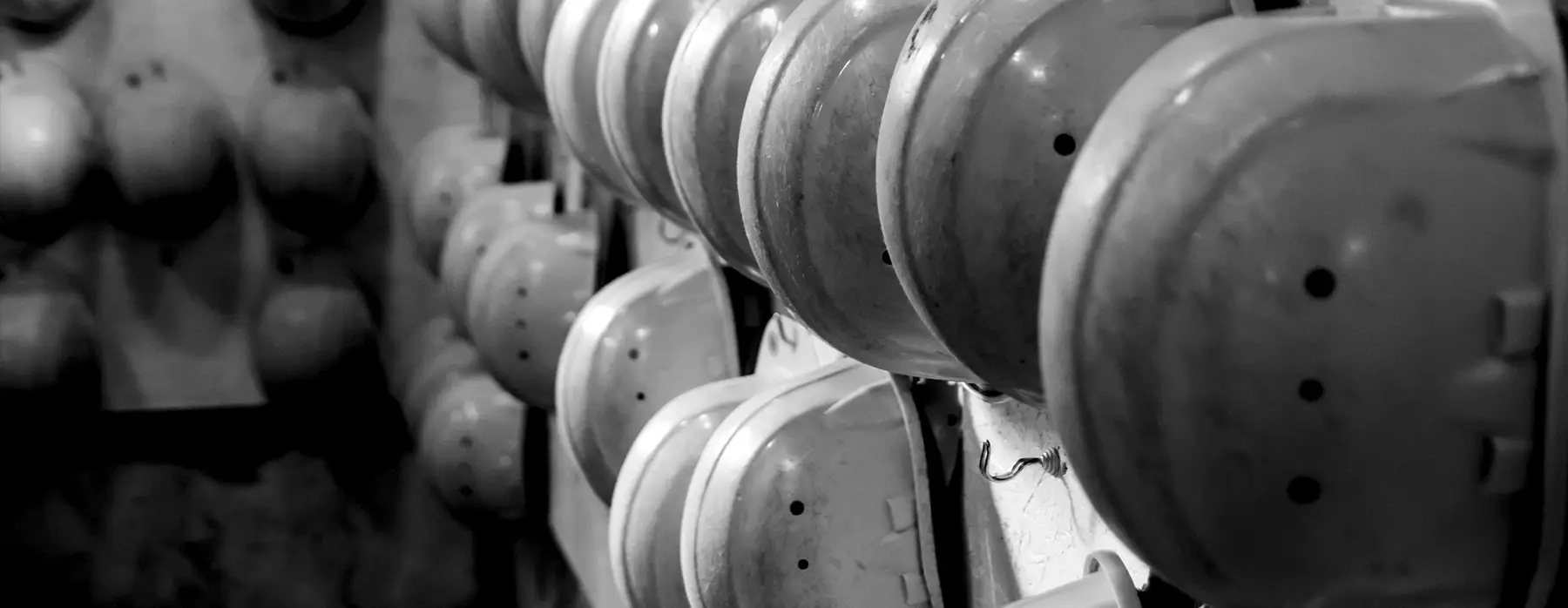 Hardhats hanging on wall rack